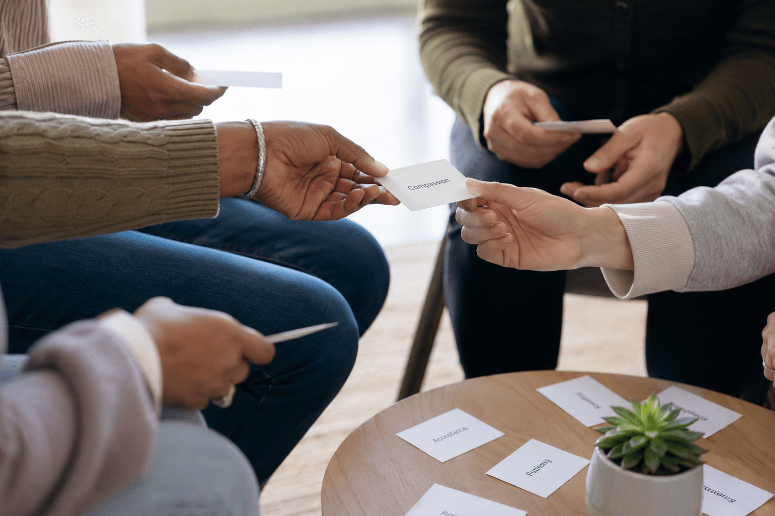 Gruppe tauscht in einer Sitzung Kärtchen aus, soziales Kompetenztraining